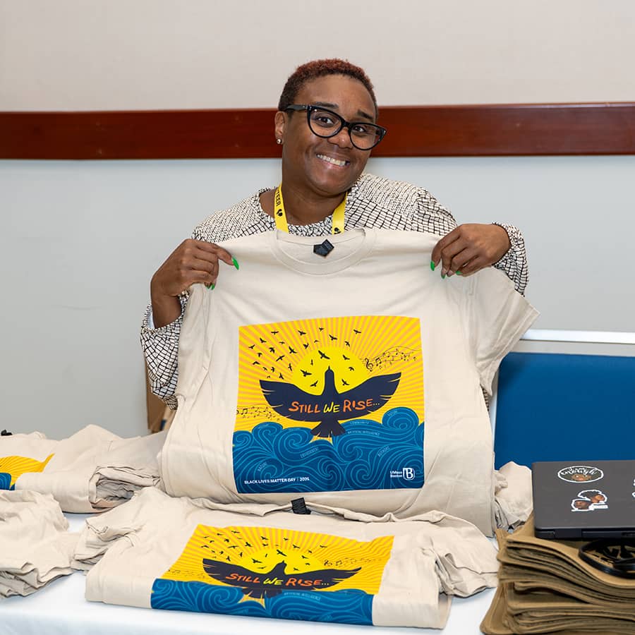 Volunteer holding up Black Lives Matter Day T-Shirt