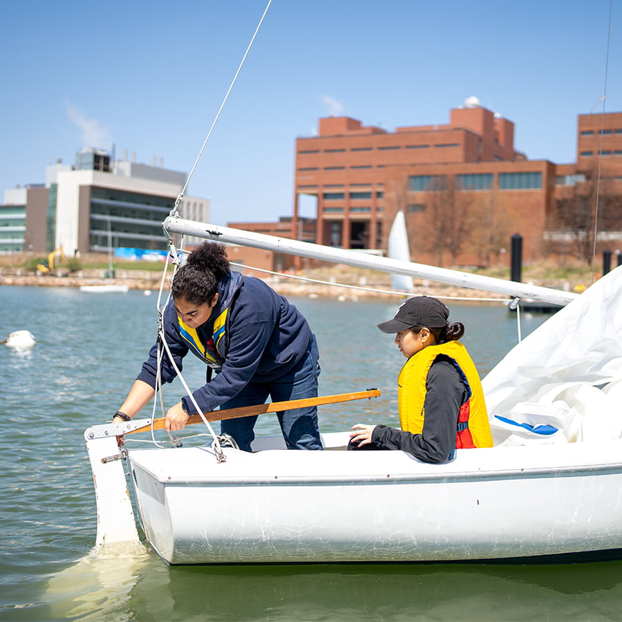Two students in sailboat Savin Hill Cove.