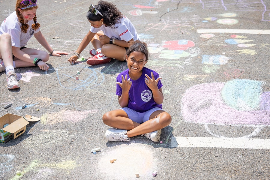 Camp Shriver girl with chalk sidewalk