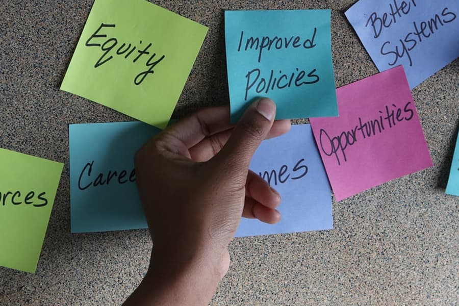 Stickies on a board with words, equity, poverty reduction,  social supports, opportunity.