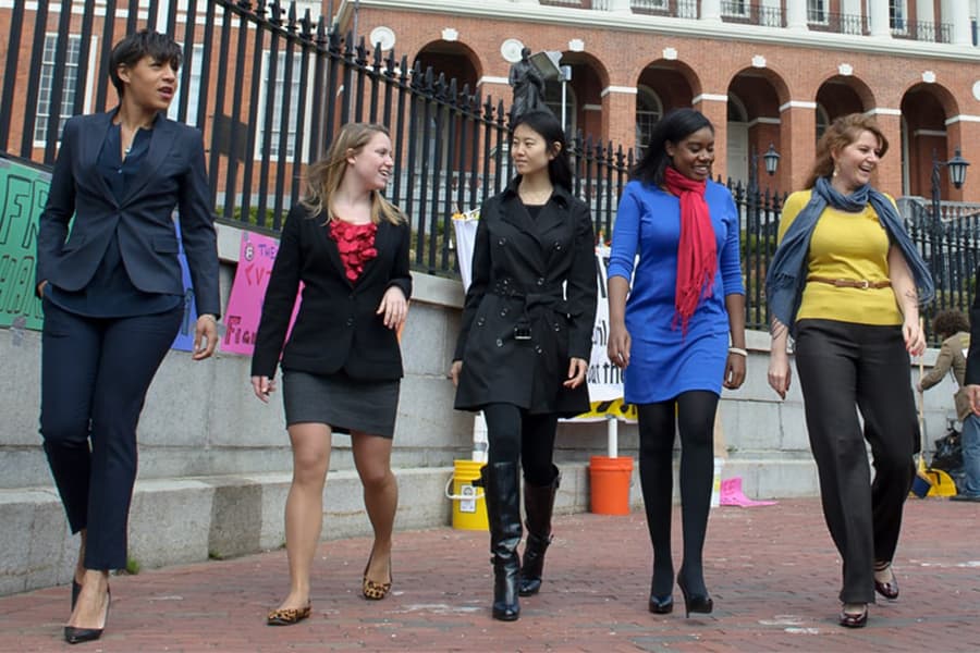 Women walk in front of the State House in Boston