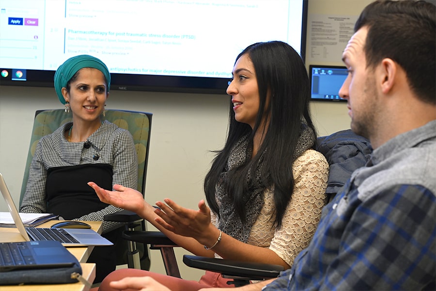 Students talk in a graduate seminar.