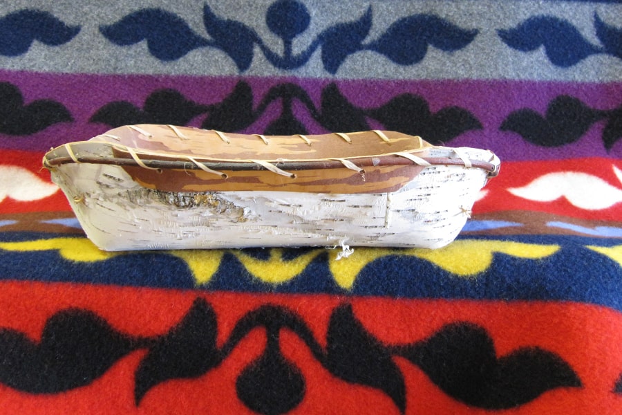 Native American basket on a blanket.