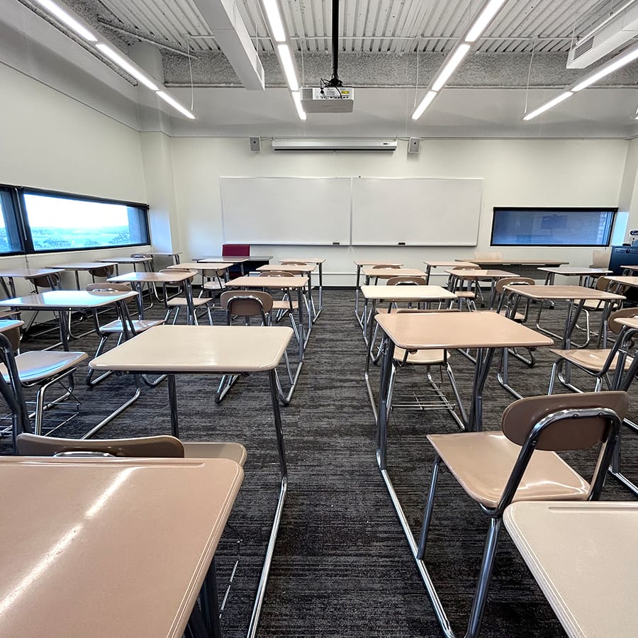 McCormack empty classroom showing whiteboard and computer monitor on teachers desk.