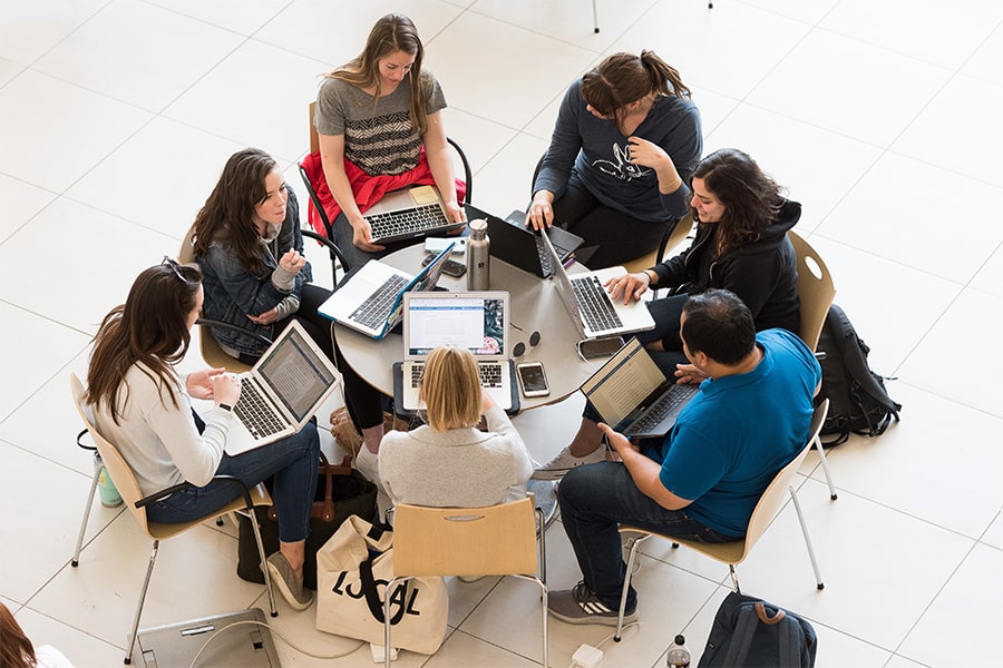 students collaborating on laptop shot from above