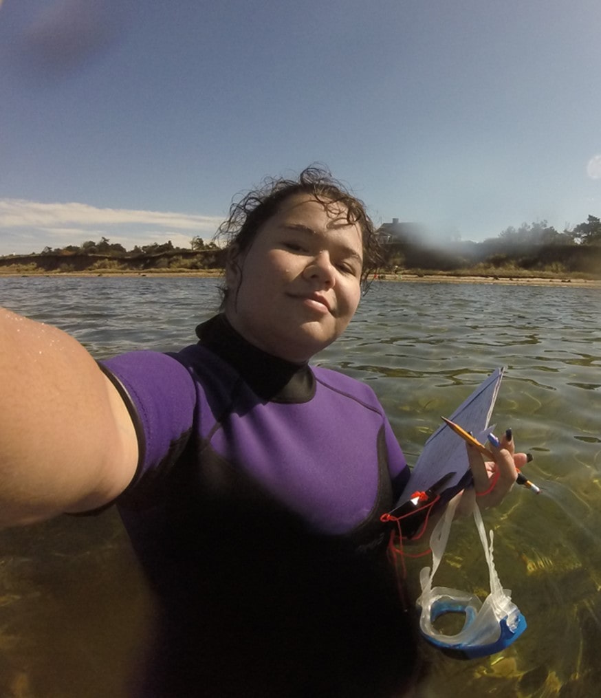 Student in purple wetsuit in the water