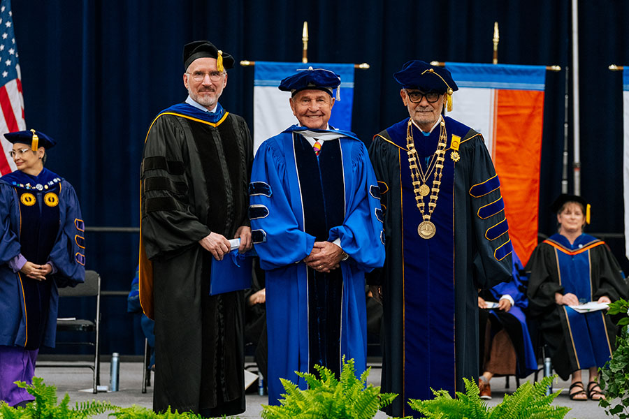 John Hoff, recipient of an honorary degree in 2026, stands between Provost Berger and Chancellor Suárez-Orozco.