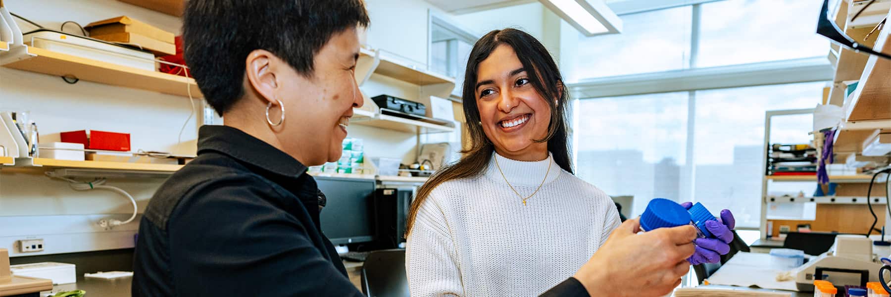 Professor Schifferli and Graduate Student working together in the research lab.