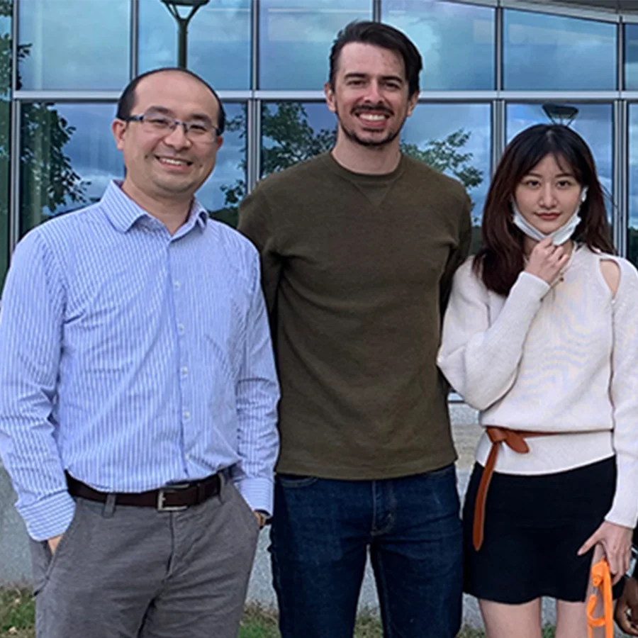 Kai Zou poses with students outside the ISC.