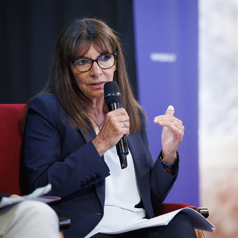 Paris Mayor, Anne Hidalgo, speaking into a microphone.