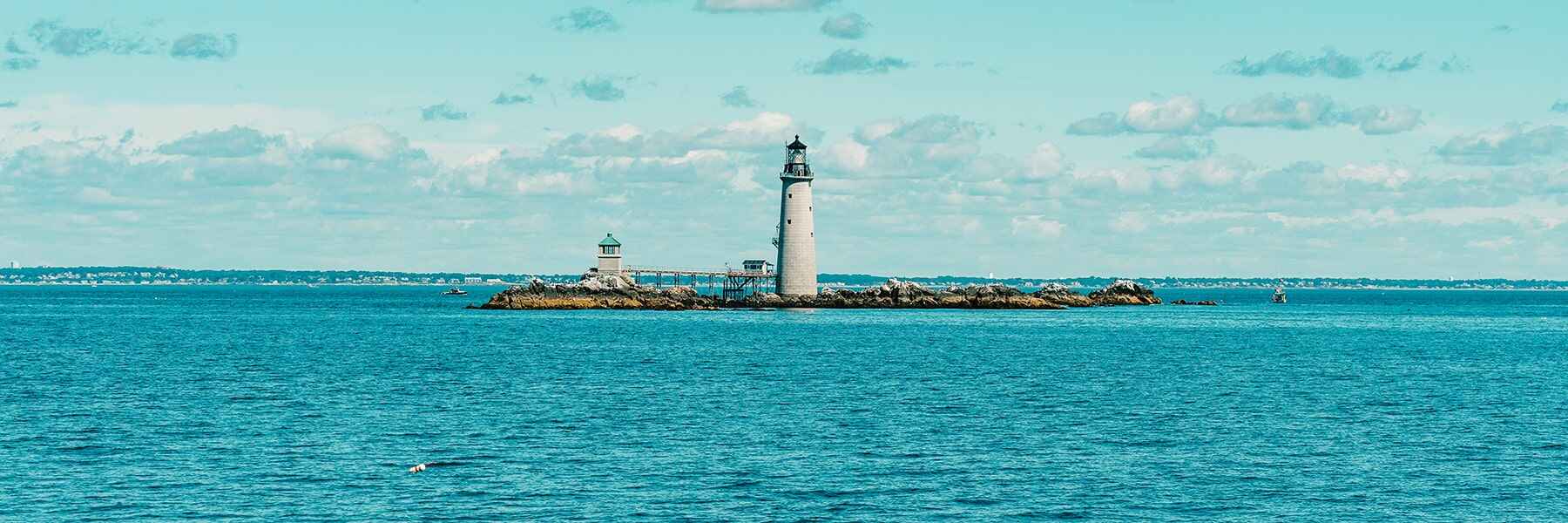 Lighthouse on island in the water.