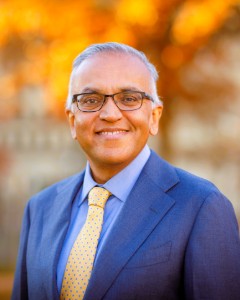Photo of Dr. Ashish K. Jha outdoors in front of a tree with orange and yellow leaves.